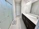 Bathroom with double vanity, large mirror, and glass shower at 3823 Spruce Creek Dr, Lakeland, FL 33811