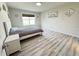 Bedroom with grey wood flooring, neutral walls, and natural light at 3823 Spruce Creek Dr, Lakeland, FL 33811
