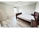 Bright bedroom with a queen bed frame, side tables, and light wood-style flooring at 3823 Spruce Creek Dr, Lakeland, FL 33811