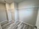 Walk-in closet with hardwood flooring and wire shelving for ample storage at 3823 Spruce Creek Dr, Lakeland, FL 33811