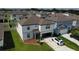 Aerial view of modern two-story home with well-kept lawn in residential neighborhood at 3823 Spruce Creek Dr, Lakeland, FL 33811