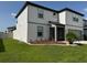 Stylish two-story home with well-kept lawn and landscaping, and a gray two-car garage at 3823 Spruce Creek Dr, Lakeland, FL 33811