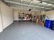 Spacious two-car garage with shelving unit and clean epoxy flooring at 3823 Spruce Creek Dr, Lakeland, FL 33811