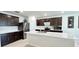Spacious kitchen featuring a large island, stainless steel appliances, and dark wood cabinetry at 3823 Spruce Creek Dr, Lakeland, FL 33811