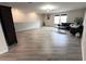 Spacious living room with hardwood floors, black sofas, and ample natural light at 3823 Spruce Creek Dr, Lakeland, FL 33811