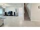 Bright living room with tile floors, modern lighting fixture and stairway to upper level at 3823 Spruce Creek Dr, Lakeland, FL 33811