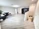 Open-concept living room with light flooring, featuring comfortable seating and modern decor at 3823 Spruce Creek Dr, Lakeland, FL 33811