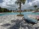 Relaxing community pool area with palm trees, lounge chairs, and clear blue water at 3823 Spruce Creek Dr, Lakeland, FL 33811