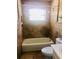Bathroom features a tiled shower and tub with a window for natural light at 385 Lynchfield Ave, Altamonte Springs, FL 32714