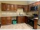 Kitchen with warm wood cabinets, stainless steel appliances and tiled backsplash at 385 Lynchfield Ave, Altamonte Springs, FL 32714