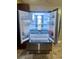 Open refrigerator with beverage cans, glass shelves, and drawer at 385 Lynchfield Ave, Altamonte Springs, FL 32714