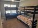 Functional bedroom featuring two sets of bunk beds with carpeting and a double hung window at 4011 Venetian Bay Village # 104, Kissimmee, FL 34741