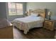 Primary bedroom with warm lighting and wood floors and coordinated nightstands at 4011 Venetian Bay Village # 104, Kissimmee, FL 34741