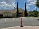 Inviting clubhouse featuring manicured landscaping, convenient parking, and accessible entrance at 4011 Venetian Bay Village # 104, Kissimmee, FL 34741