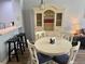 Dining room featuring an vintage hutch, table, and chairs with black barstools and hardwood floors at 4011 Venetian Bay Village # 104, Kissimmee, FL 34741