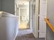 Upstairs hallway with carpeted floors, freshly painted walls, and views of the bathroom at 4011 Venetian Bay Village # 104, Kissimmee, FL 34741