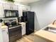 Efficient kitchen featuring stainless steel appliances, light countertops and white painted cabinets at 4011 Venetian Bay Village # 104, Kissimmee, FL 34741