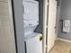 Convenient in-unit laundry featuring a stacked washer and dryer behind a door at 4011 Venetian Bay Village # 104, Kissimmee, FL 34741