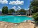 A large community pool with lounge chairs and umbrellas is perfect for relaxation at 4011 Venetian Bay Village # 104, Kissimmee, FL 34741