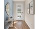 Charming entryway with hardwood floors, a modern mirror, and a stylish console table at 444 Free Range Dr, Clermont, FL 34715