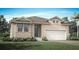 Charming single-Gathering home with a two-car garage, manicured lawn, and inviting front entrance at 444 Free Range Dr, Clermont, FL 34715