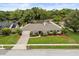 Lovely one-story home featuring a well-maintained lawn, lush greenery, and a quaint residential setting at 548 Timber Ridge Dr, Longwood, FL 32779