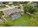 Aerial view of a home with a screened-in pool and a spacious green backyard at 548 Timber Ridge Dr, Longwood, FL 32779