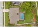Aerial view of a home with a screened-in pool and a well-manicured lawn at 548 Timber Ridge Dr, Longwood, FL 32779