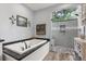 Bright bathroom features a modern glass shower, soaking tub, and granite vanity at 548 Timber Ridge Dr, Longwood, FL 32779