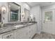 Bathroom with granite countertop, double sinks, and decorative mirrors at 548 Timber Ridge Dr, Longwood, FL 32779