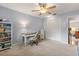 Bedroom with carpet floor, ceiling fan, desk, shelving, closet and door at 548 Timber Ridge Dr, Longwood, FL 32779