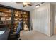 Carpeted bedroom features a bookshelf with ladder, chair, and closet at 548 Timber Ridge Dr, Longwood, FL 32779