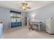 Bedroom with carpet flooring, ceiling fan, desk, shelving and storage cubes at 548 Timber Ridge Dr, Longwood, FL 32779