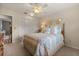 This bedroom has a ceiling fan, closet, floral bedding and two decorative pictures at 548 Timber Ridge Dr, Longwood, FL 32779