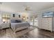 Bright primary bedroom with a king bed, hardwood floors, and direct access to the pool area through French doors at 548 Timber Ridge Dr, Longwood, FL 32779