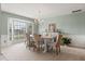 Bright dining room with a chandelier, bay window, and wainscoting creating an elegant atmosphere at 548 Timber Ridge Dr, Longwood, FL 32779