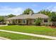 Beautiful single-story home with lush green lawn and mature landscaping creating a serene curb appeal at 548 Timber Ridge Dr, Longwood, FL 32779