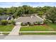 Charming single-story home with well-maintained landscaping, a manicured lawn, and a welcoming facade at 548 Timber Ridge Dr, Longwood, FL 32779