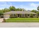 Charming single-story home featuring manicured landscaping and a brick facade with a welcoming front lawn at 548 Timber Ridge Dr, Longwood, FL 32779