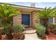 Inviting front entrance featuring a brick walkway leading to a blue door framed by lush greenery at 548 Timber Ridge Dr, Longwood, FL 32779
