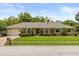 Charming single-story home with manicured lawn, mature trees, and inviting front entrance at 548 Timber Ridge Dr, Longwood, FL 32779