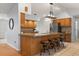 Spacious kitchen featuring a large island with seating, ample cabinet space, and stylish lighting fixtures at 548 Timber Ridge Dr, Longwood, FL 32779