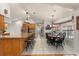 Long kitchen with stainless steel appliances, seating and dining area at 548 Timber Ridge Dr, Longwood, FL 32779