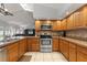 Bright kitchen featuring tile floors, stainless steel appliances, and wooden cabinets at 548 Timber Ridge Dr, Longwood, FL 32779