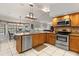 Spacious kitchen with stainless steel dishwasher, modern appliances and an adjacent dining area at 548 Timber Ridge Dr, Longwood, FL 32779