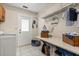 Bright laundry room with tile flooring, storage shelves, and convenient access to the outside at 548 Timber Ridge Dr, Longwood, FL 32779