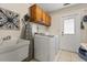 Laundry room with washer, dryer, laundry sink, and overhead storage at 548 Timber Ridge Dr, Longwood, FL 32779