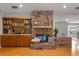 Cozy living room with a brick fireplace, built-in shelves, and hardwood floors at 548 Timber Ridge Dr, Longwood, FL 32779