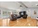 Open floor plan living room with hardwood floors, leather furniture, and natural light at 548 Timber Ridge Dr, Longwood, FL 32779