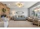 Cozy living room with brick fireplace, comfortable seating, and large window, perfect for relaxation at 548 Timber Ridge Dr, Longwood, FL 32779